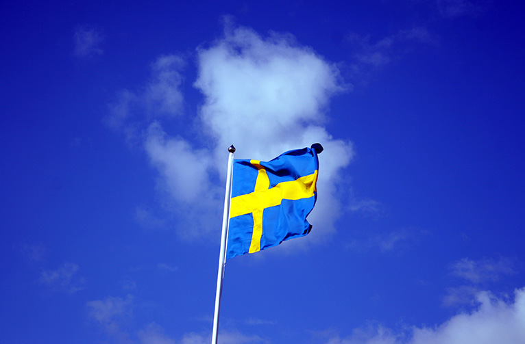 Swedish_flag_with_blue_sky_behind